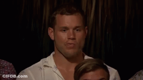 Man Sitting In Dark Room With Other Men GIF