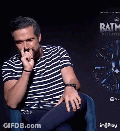 Man Sitting In Front Of Batman Poster GIF