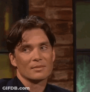 Man Sitting In Front Of Brick Wall GIF