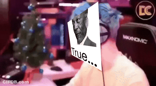 Man Sitting In Front Of Christmas Tree And Maxnomic Chair GIF