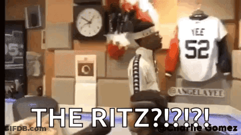 Man Sitting In Front Of Clock And Jersey Number 52 GIF