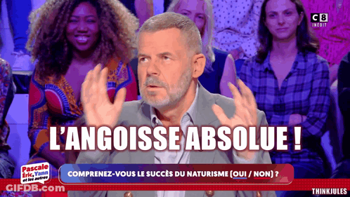 Man Sitting In Front Of Crowd With L'angoisse Absolue GIF