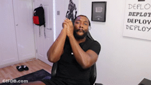 Man Sitting In Front Of Deploy Sign GIF