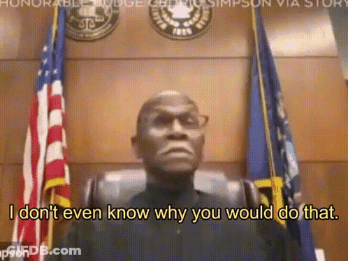 Man Sitting In Front Of Flags Saying I Don T Know Why You Would Do That GIF