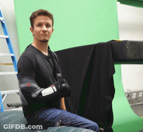 Man Sitting In Front Of Green Screen With Letters CB GIF
