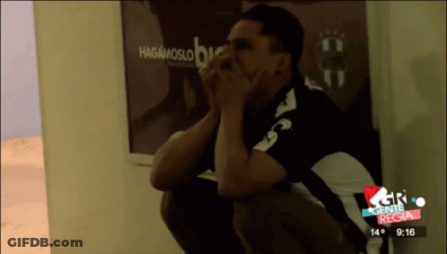 Man Sitting In Front Of Hagamoslo Sign GIF