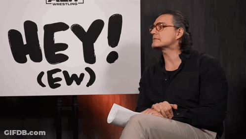 Man Sitting In Front Of Hey Ew Sign GIF
