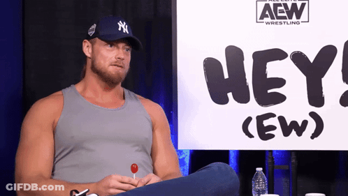 Man Sitting In Front Of Hey (Ew) Sign GIF