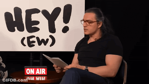 Man Sitting In Front Of Hey (Ew) Sign GIF