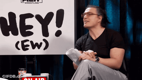 Man Sitting In Front Of Hey Sign GIF