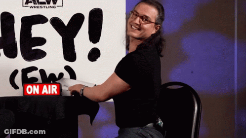 Man Sitting In Front Of Hey Sign GIF