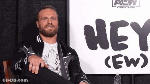 Man Sitting In Front Of Hey Sign GIF
