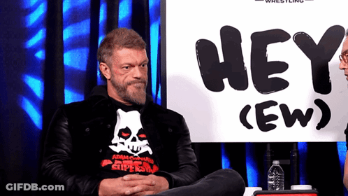 Man Sitting In Front Of Hey Sign GIF