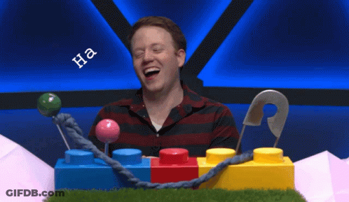 Man Sitting In Front Of Lego Blocks With Ummm Shirt GIF