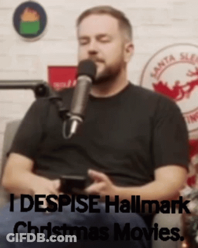 Man Sitting In Front Of Microphone Saying I Despise Hallmark Christmas Movies GIF