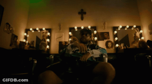 Man Sitting In Front Of Mirror With Cross GIF