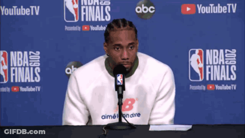 Man Sitting In Front Of NBA Finals Banner GIF