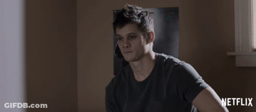 Man Sitting In Front Of Netflix Poster GIF