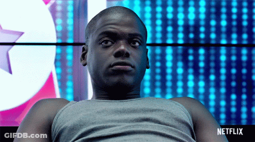 Man Sitting In Front Of Netflix Sign GIF