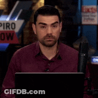 Man Sitting In Front Of Piro Show Sign GIF