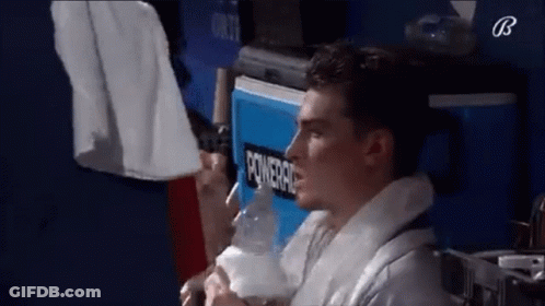 Man Sitting In Front Of Powerade Cooler GIF