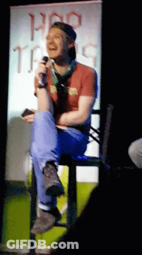Man Sitting In Front Of Pro Tips Sign GIF