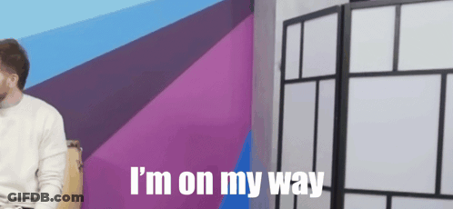 Man Sitting In Front Of Purple Wall With I M On My Way GIF