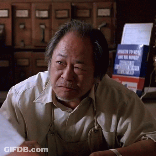 Man Sitting In Front Of Register To Vote Sign GIF