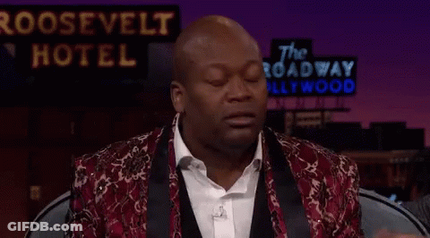 Man Sitting In Front Of Roosevelt Hotel Sign GIF