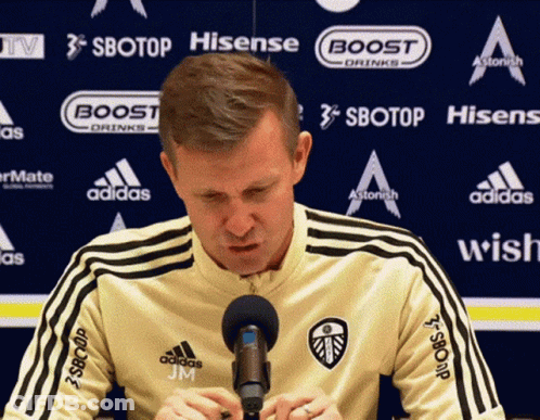 Man Sitting In Front Of Sbotop Banner GIF