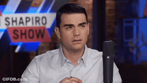 Man Sitting In Front Of Shapiro Show Sign GIF