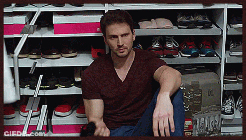 Man Sitting In Front Of Shoe Rack With I'm Sorry Box GIF