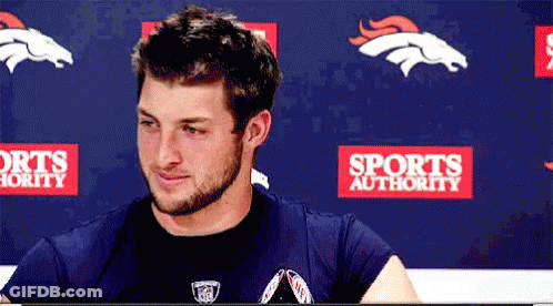 Man Sitting In Front Of Sports Authority Banner GIF