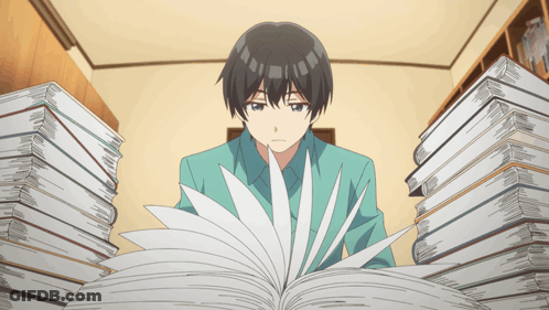 Man Sitting In Front Of Stack Of Books GIF