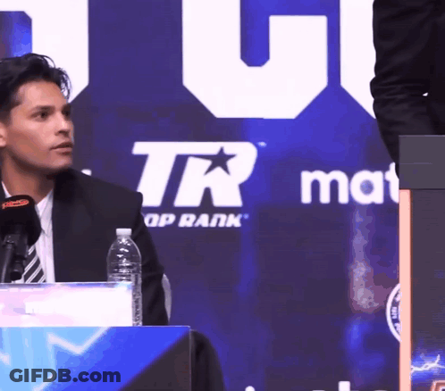 Man Sitting In Front Of TR Group Rank Sign GIF