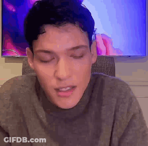 Man Sitting In Front Of TV With Eyes Closed GIF