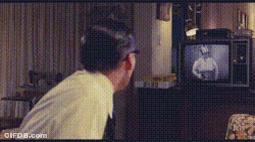 Man Sitting In Front Of TV With Man Picture GIF