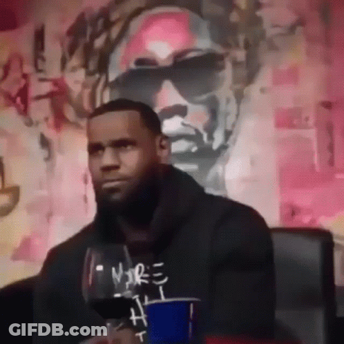 Man Sitting In Front Of Wall With Painting Of Sunglasses GIF