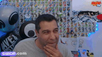 Man Sitting In Front Of Wall With Smash Jt GIF
