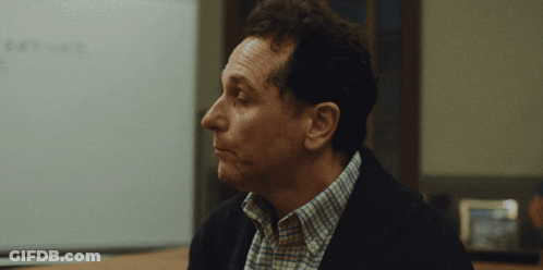 Man Sitting In Front Of Whiteboard Saying Exit GIF