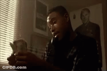 Man Sitting In Front Of Window Holding Money GIF