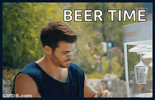 Man Sitting In Front Of Wine Glass Dispenser With Beer Time GIF