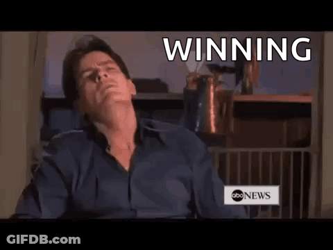 Man Sitting In Front Of Winning Sign GIF