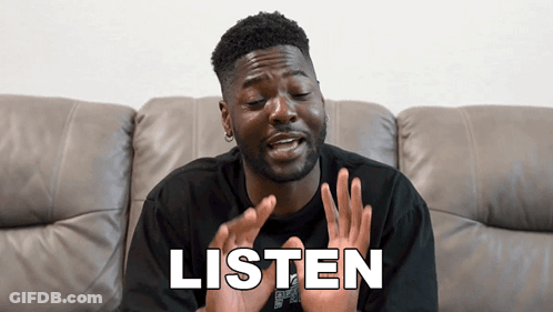Man Sitting In Grass Covering Ears GIF