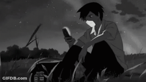 Man Sitting In Grass Looking At Cell Phone GIF