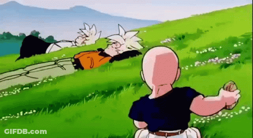 Man Sitting In Grass Looking At Lying Man GIF