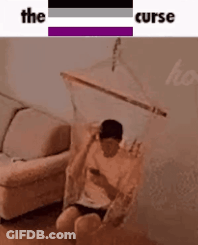 Man Sitting In Hammock Looking At Cell Phone GIF