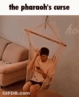 Man Sitting In Hammock Looking At Phone GIF