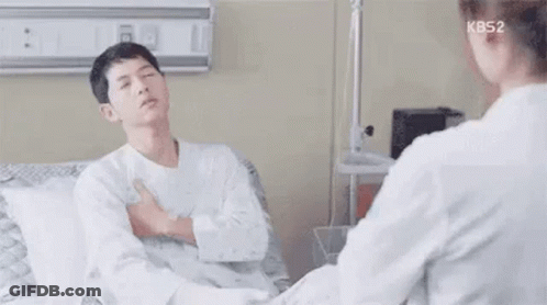 Man Sitting In Hospital Bed Talking To Doctor GIF