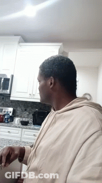 Man Sitting In Kitchen Looking GIF